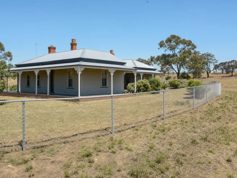 Galvanised chain mesh fence around a farmhouse yard on a rural block in regional Victoria